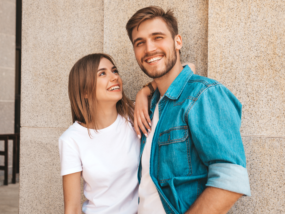 Happy Couple Sharing Bright Smiles – Orthodontist in Arcadia CA A cheerful couple stands together outdoors, smiling confidently with healthy teeth that reflect excellent orthodontic care – Orthodontist in Arcadia CA.
